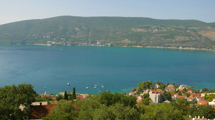 A picturesque view of the historic city of Herceg Novi. The old fortress and part of the historic building are picturesquely stretched over the Adriatic. A visible entrance to Boka Kotorska.