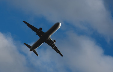 Silhouette of a plane taking off against the blue sky
