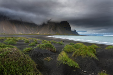 Group of people walking Vestrahorn beach in Iceland