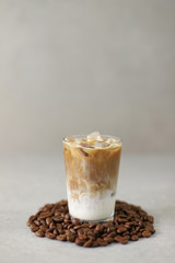 Iced coffee latte isolated on coffee beans
