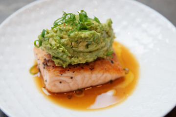 Salmon steak with avocado sauce