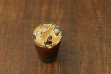 Iced coffee black coffee isolated on wooden table
