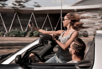 Fototapeta na wymiar young woman taking a selfie in the car