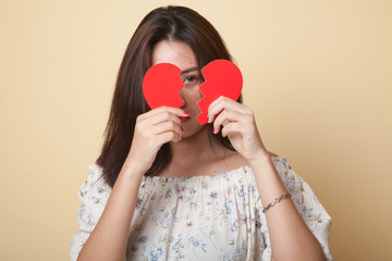 Beautiful young Asian woman with broken heart.