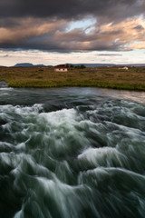 Summer Iceland Landscape with Raging River at Overcast Weather