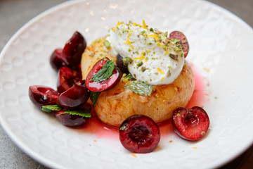 Grilled peach, sweet cherries and whipped cream