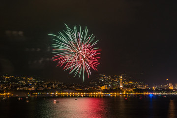 fireworks over the lake of como lecco during a summer night of party