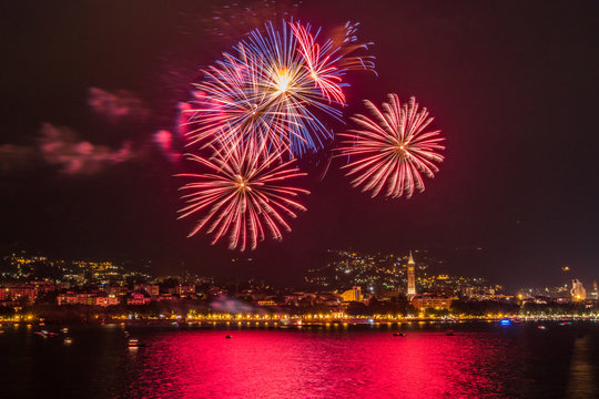 fireworks over the lake of como lecco during a summer night of party