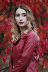 A girl in a leather jacket, autumn park, an autumn photo session of a girl in a leather jacket