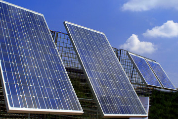 Solar panels for energy production with blue sky on background