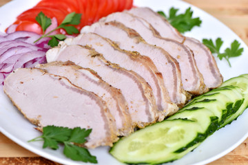 Sliced ham for the holiday. Baked ham with vegetables.