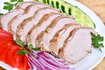 Sliced ham for the holiday. Baked ham with vegetables.