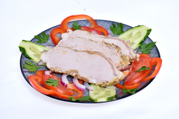 Sliced ham for the holiday. Baked ham with vegetables.
