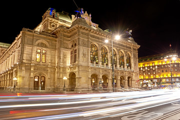Vienna State Opera at night with car light trails on the Vienna Ring street.