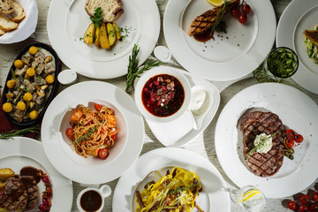 Different types of dishes on the table, top view. Concept for restaurant menu