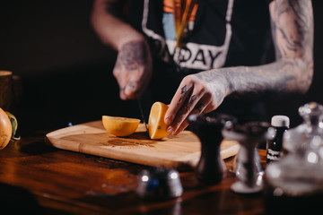 The process of cooking shisha, hookah bowl.Fruit in ice shaking.Citrus fruit for Shisha.Tattooed hands
