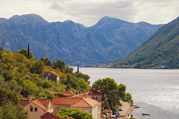 Obraz premium Beautiful Mediterranean landscape on a cloudy autumn day. Montenegro, Adriatic Sea, Bay of Kotor. View of the ancient town of Perast