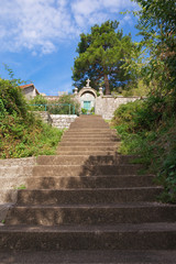 Fototapeta na wymiar Steep stairs to a small church. Montenegro, Perast town