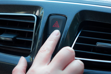 woman pushes a button in the car