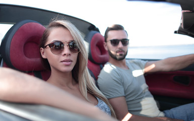 close up.the couple traveling in a convertible