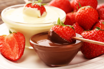 Fondue with Melting chocolate or melted chocolate and strawberry.