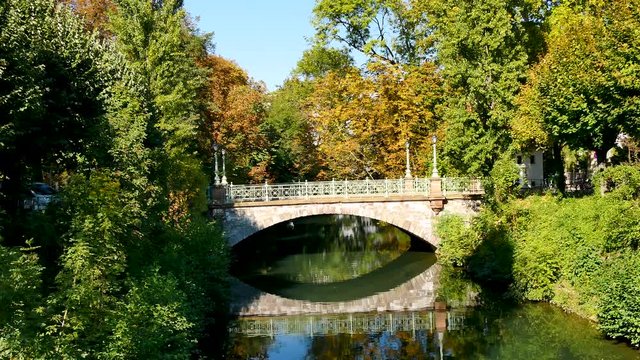 A bridge in the city of Strasbourg that is located in the middle of the greenery. Strasbourg is a city in eastern France. Filmed in October 2018.