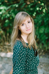 Fototapeta premium Beautiful young woman posing in summer park