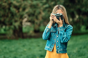 Girl taking pictures on a retro camera