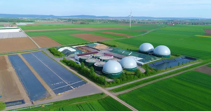 Camera flight over biogas plant from pig farm. Renewable energy from biomass. Modern agriculture European Union