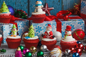 Christmas cupcakes with colored decorations, soft focus background