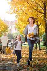 Fototapeta premium Happy time family and love abstract: mother and daughter run in autumn park