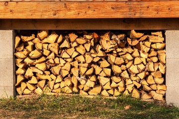 Firewood for ecological house. Fuel preparation for winter. Stored fuel for the winter. Stock of wood.