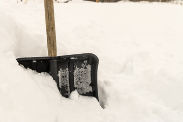 Snow shovel in the snowdrift. Shovel for cleaning the footpaths from snow.