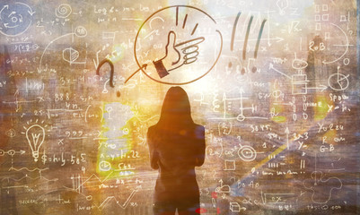 Young woman looking on the black board with mathematical formulas and calculations. Bright idea,...