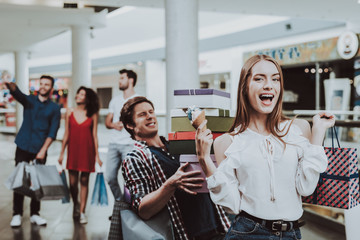 Carefree Woman with Ice Cream in Hand in Mall.