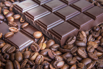 Dark chocolate bars with coffee beans closeup