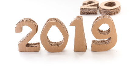 2019 and 20 waiting handmade 3D numbers made of reused cardboard paper, on white background. New year concept.