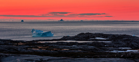 Arctic landscape in summer with icebergs at sunset  in Scoresby Sound, East Greenland