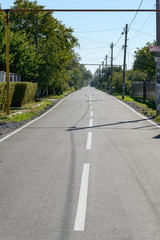 View along estate asphalt road in Ukrainian suburb.