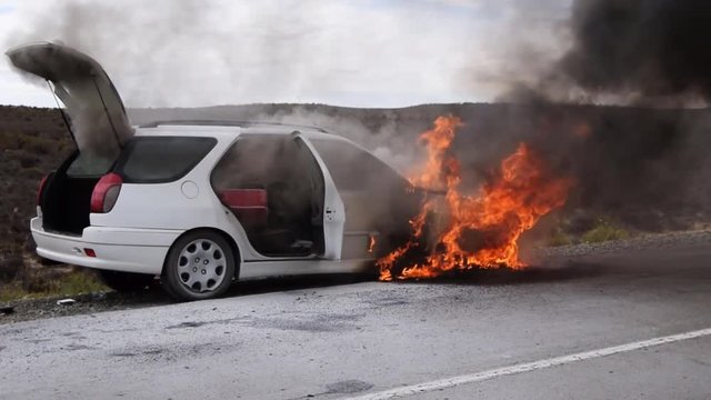 Car on fire in the middle of nowhere, end of road trip around South Africa. Slow motion
