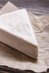 delicious creamy camembert cheese on a wooden rustic background