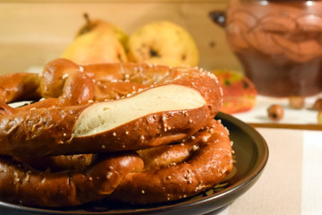 Homemade fresh pretzel on wooden kitchen. Symbolic for Oktoberfest celebration. German traditions. Salty snack for beer.