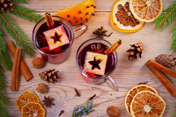 Mulled wine hot drink with spices, citrus fruits and apples. Seasonal and holidays concept. overhead, top view