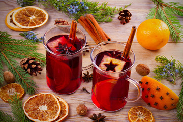 Mulled wine hot drink with spices, citrus fruits and apples. Seasonal and holidays concept