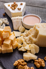 set of different cheeses on a wooden rustic background