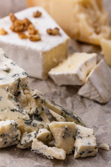 set of different cheeses on a wooden rustic background