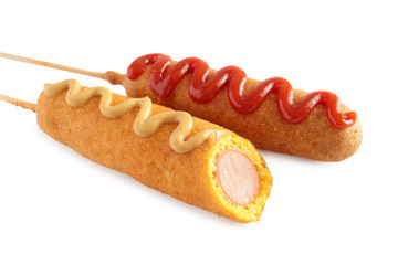 Corn dogs with ketchup and mustard isolated on white background
