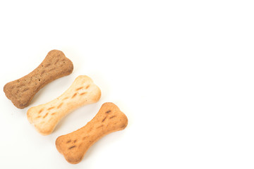 Three bone shaped dog treats on a white background with copy space