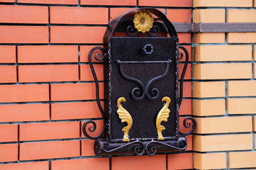 Mail metal box on a brick wall. Close-up.