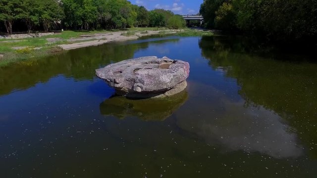 The Brushy Creek Crossing at The Round Rock, A round tabletop rock in the middle of the crossing. To this day the limestone bottom has ruts from the wagon wheels cut into it.